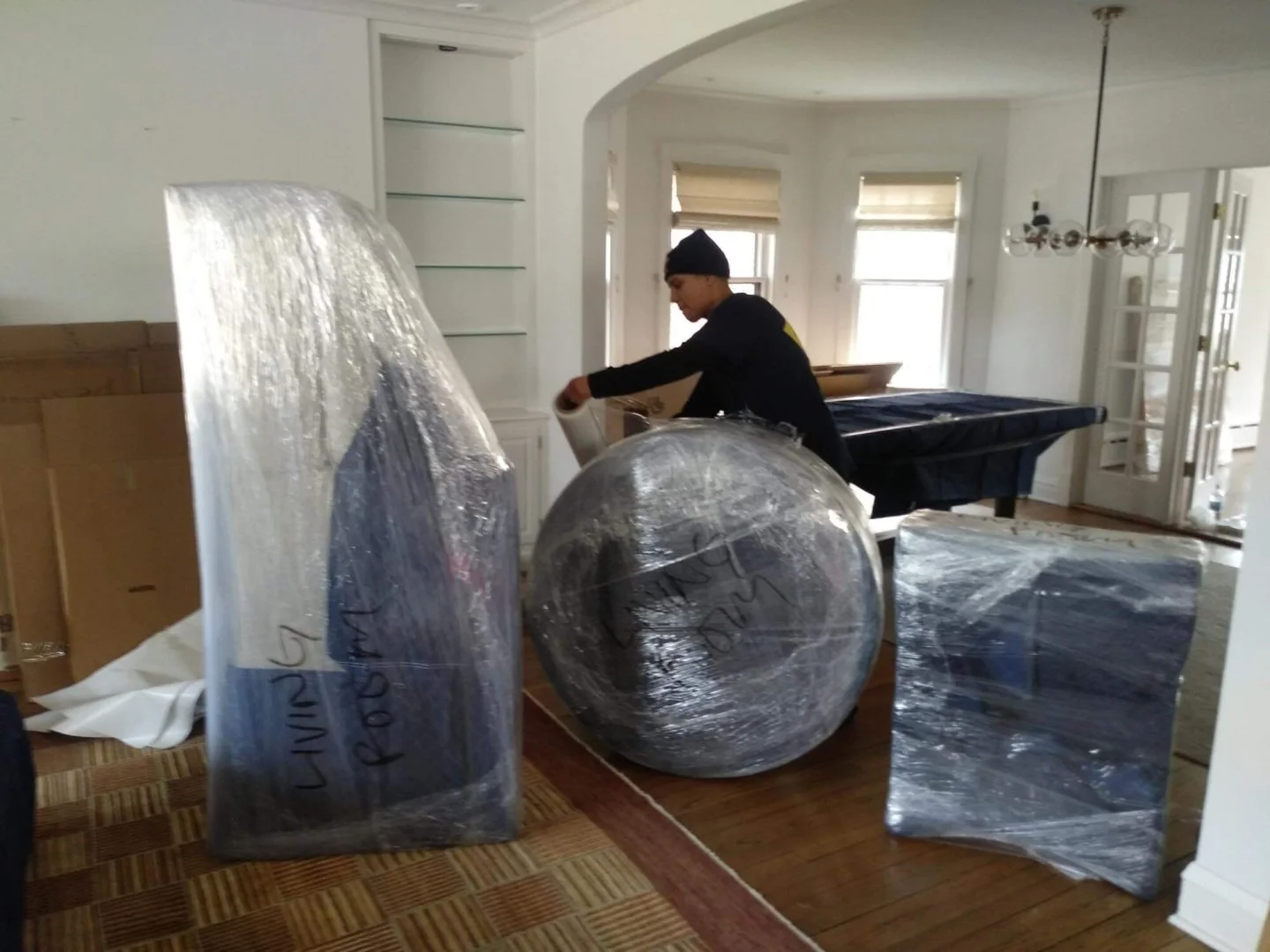 Professional movers packing furniture in a Chicago home.