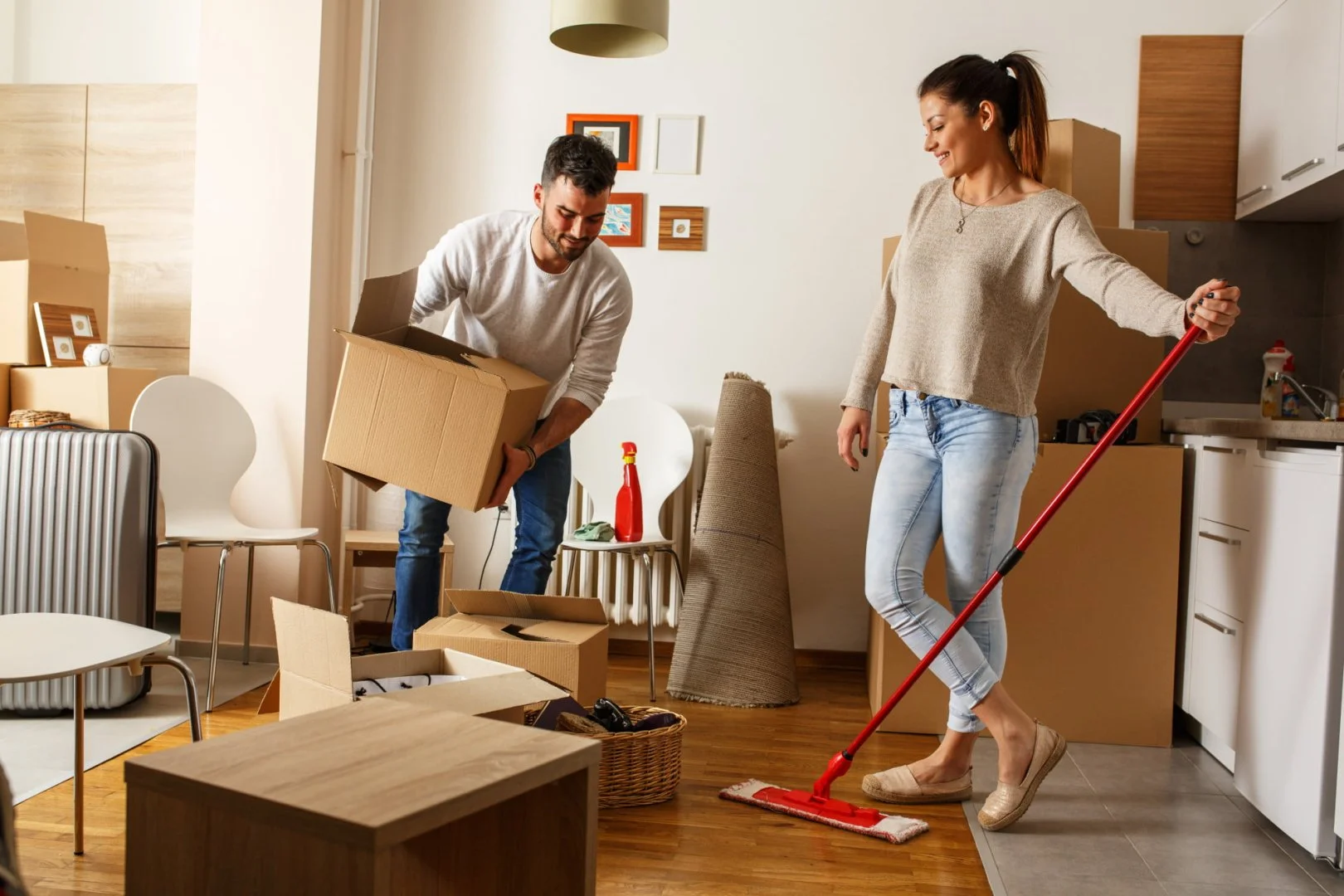Moving to a New City Couple packing boxes in a new home, local movers near me