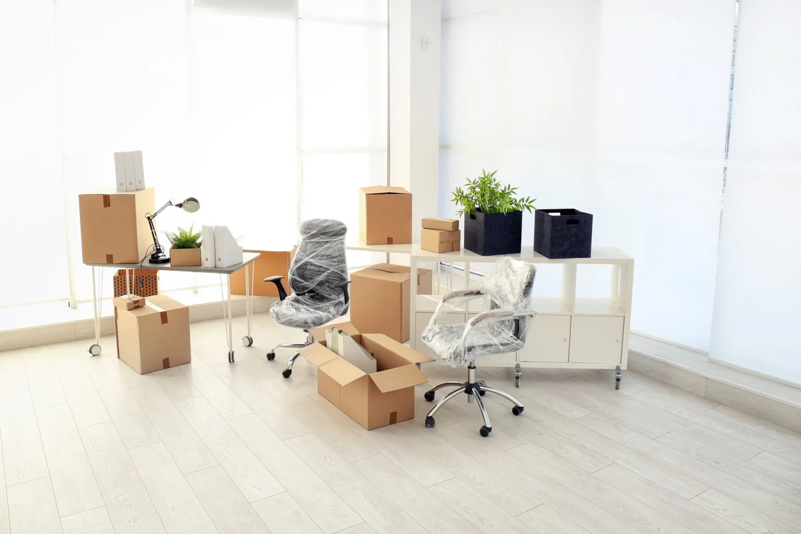 Office Move Preparation Office with moving boxes and chairs, Moovers Chicago moving services.