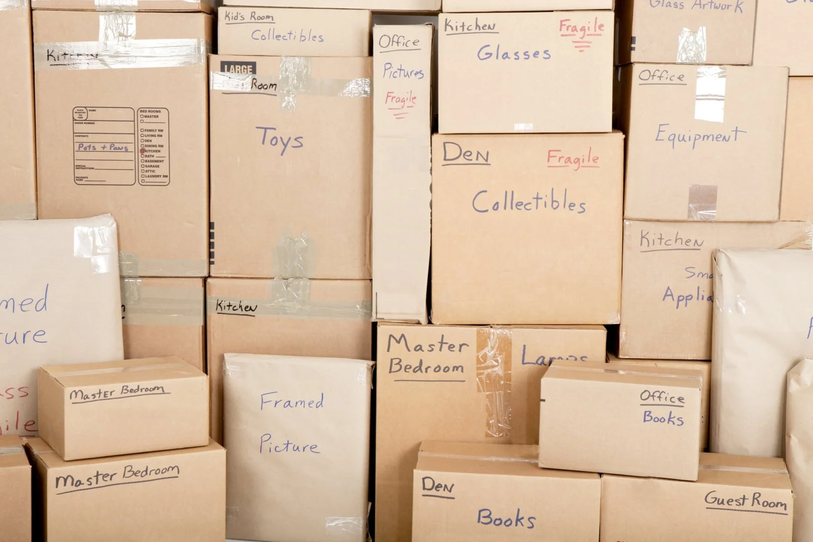 Organized Moving Boxes by Moovers Chicago Stacked moving boxes labeled for different rooms and items, Moovers Chicago.