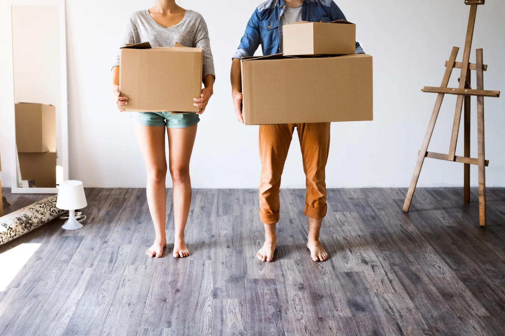 Moving Services in Chicago Couple holding boxes in a new home, moving services Chicago.