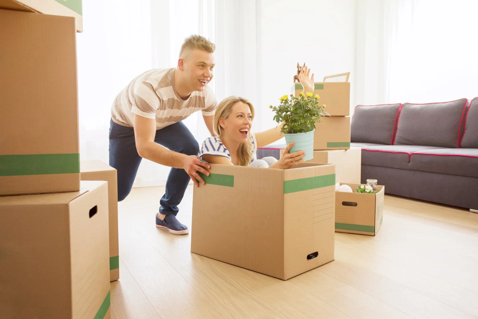Moving Day Fun with Moovers Chicago Happy couple enjoying moving day with boxes, Moovers Chicago.
