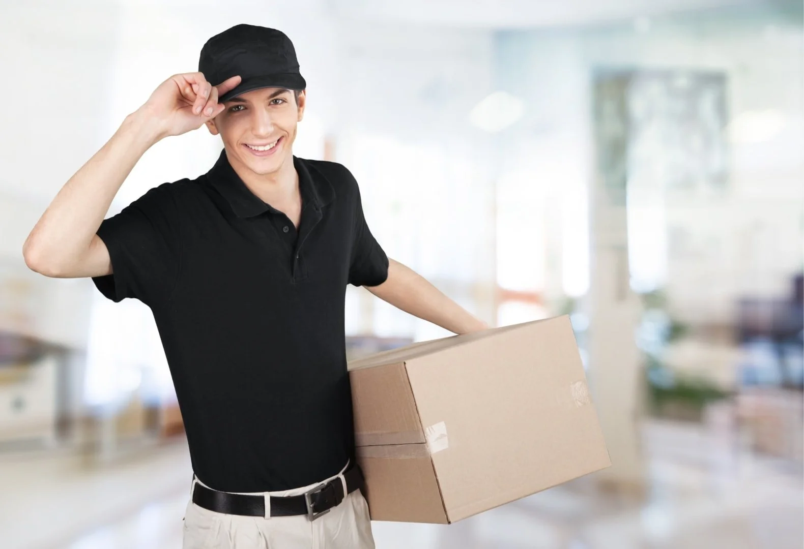 Professional Moving Services by Moovers Chicago Smiling mover holding a box, representing Moovers Chicago moving services.