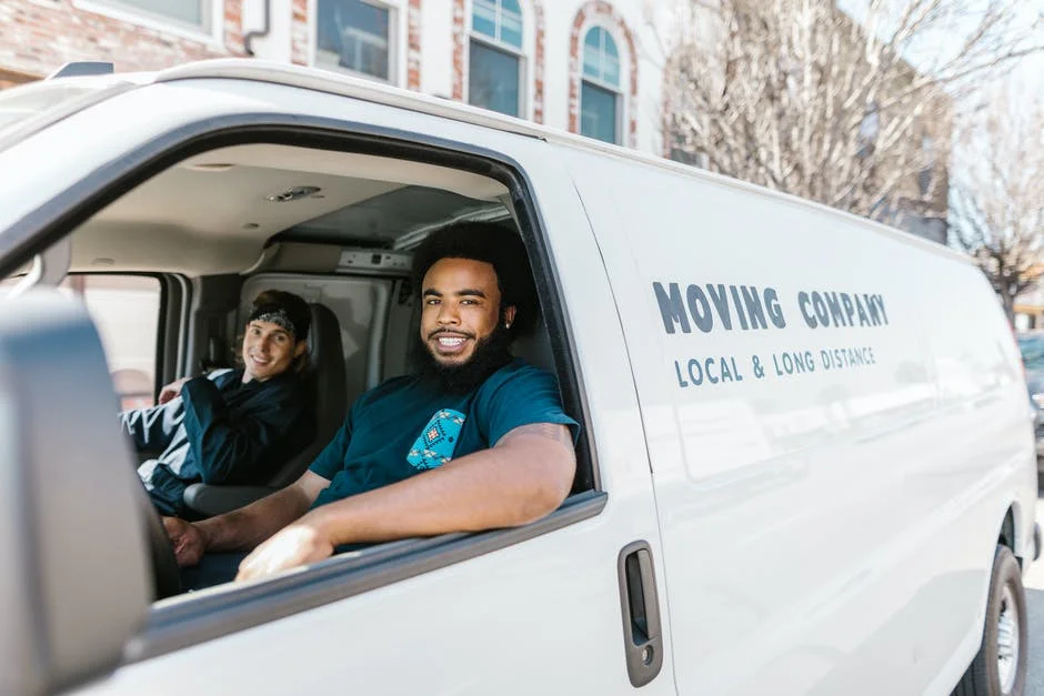 Local and Long Distance Movers Movers in a van from a local and long distance moving company.