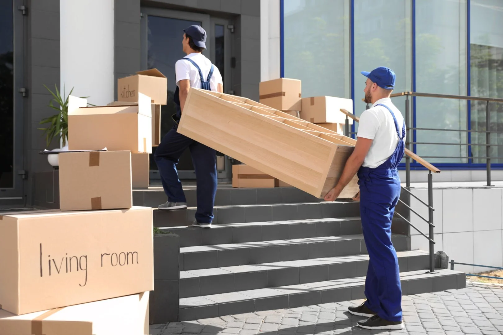Professional Moving Services in Chicago Professional movers carrying furniture and boxes into a building.