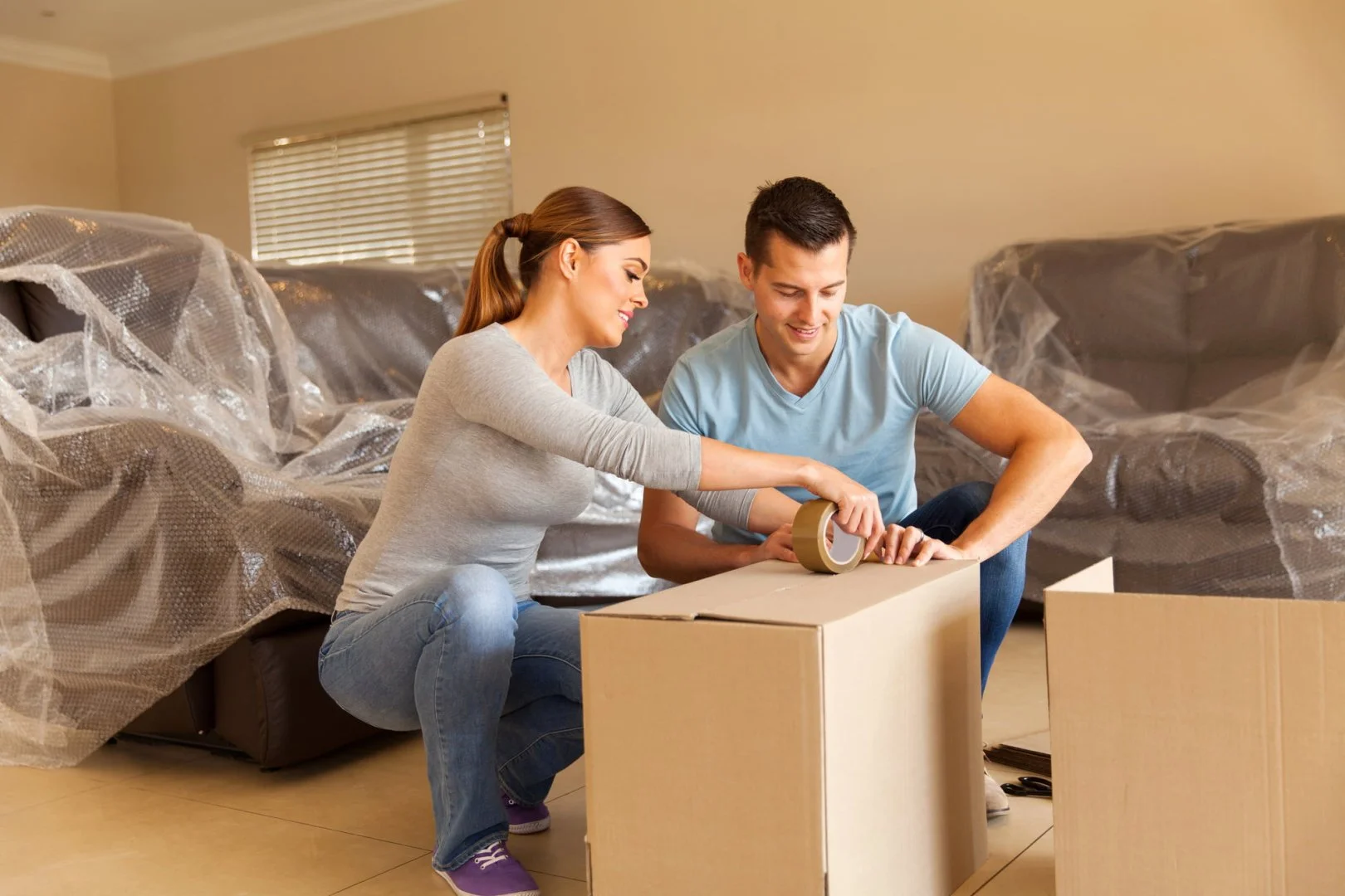 Packing Kitchen Items for Moving Couple packing kitchen items for a move with Moovers Chicago.
