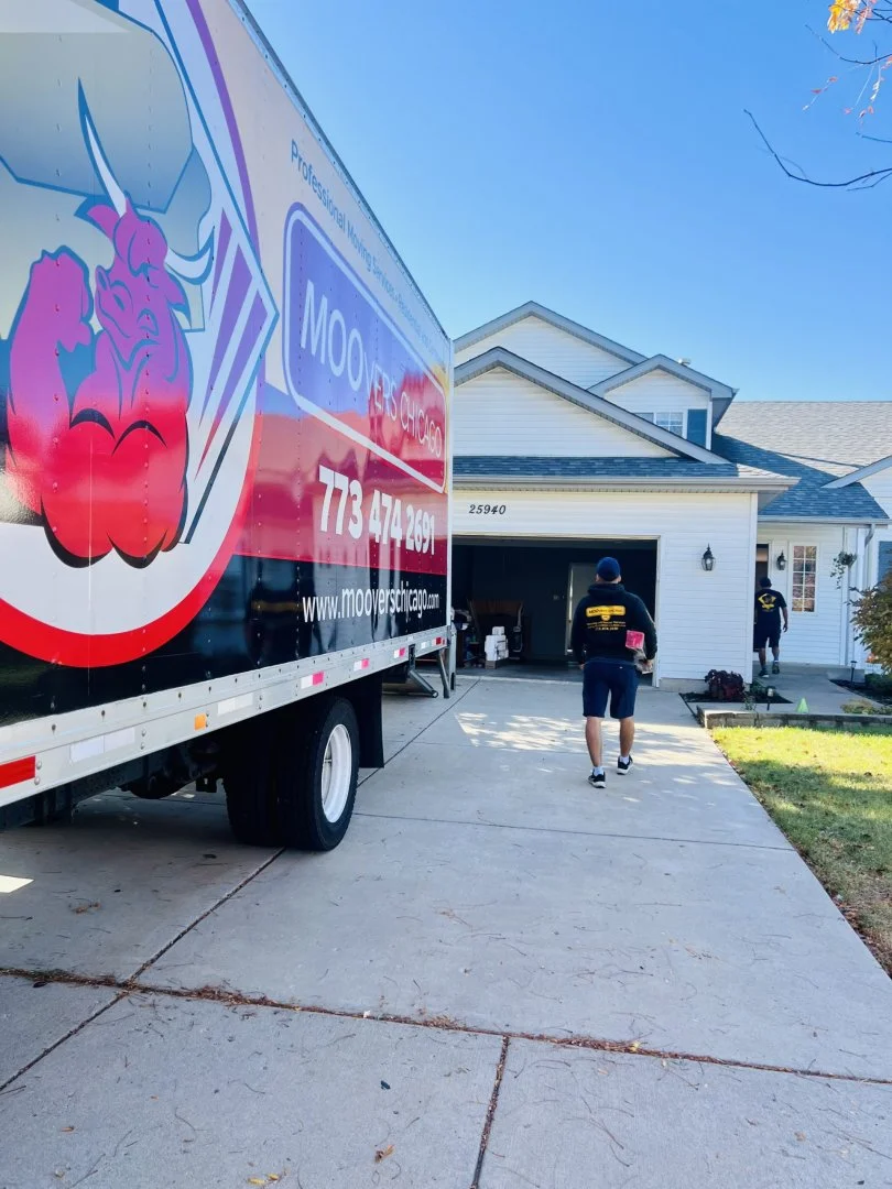 Moovers Chicago Residential Moving Service Moovers Chicago truck at residential move, movers carrying boxes.