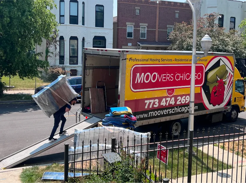 Moovers Chicago truck with movers loading furniture, local and long distance moving services.
