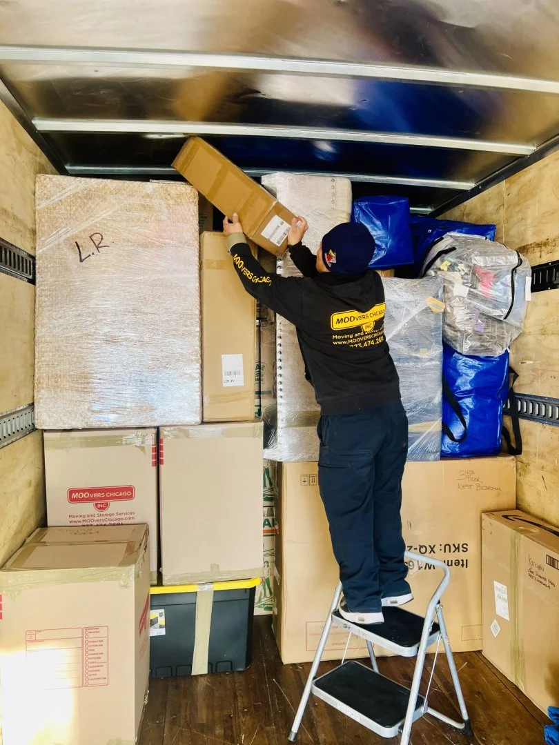 Efficient Moving Services by Moovers Chicago Professional movers organizing boxes in a truck for Moovers Chicago.