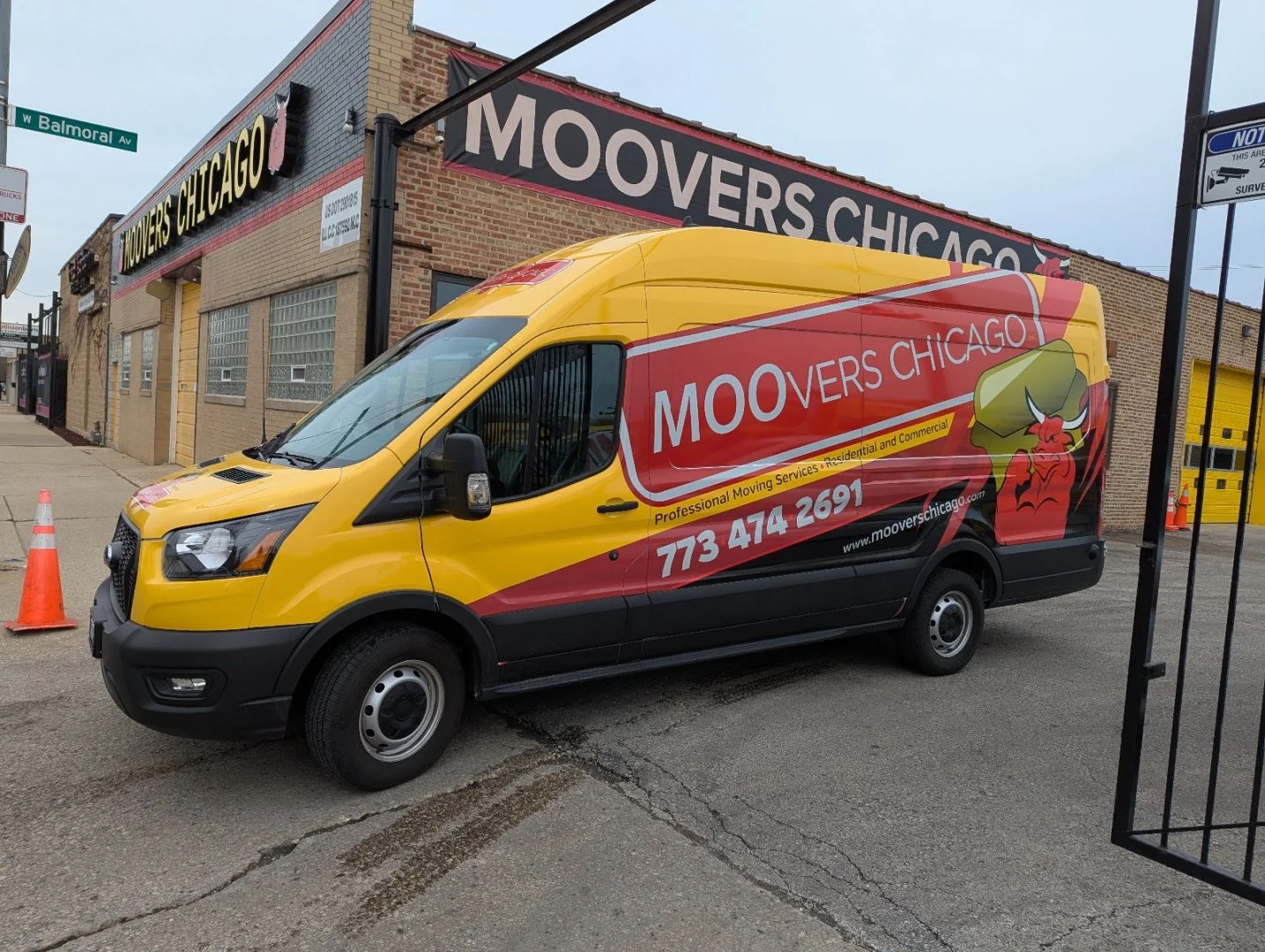 Moovers Chicago Moving Van Moovers Chicago moving van parked outside their office, offering local and long distance moving services.