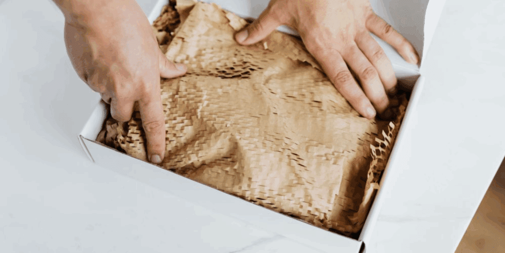 A man preparing a package in a box