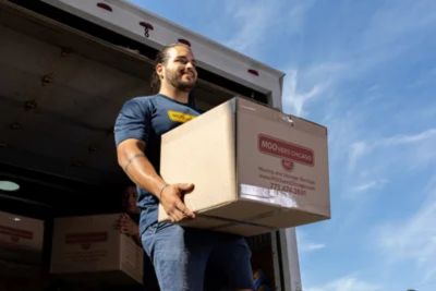 Mover carrying boxes for a commercial long-distance move with a trusted Chicago long-distance moving company.
