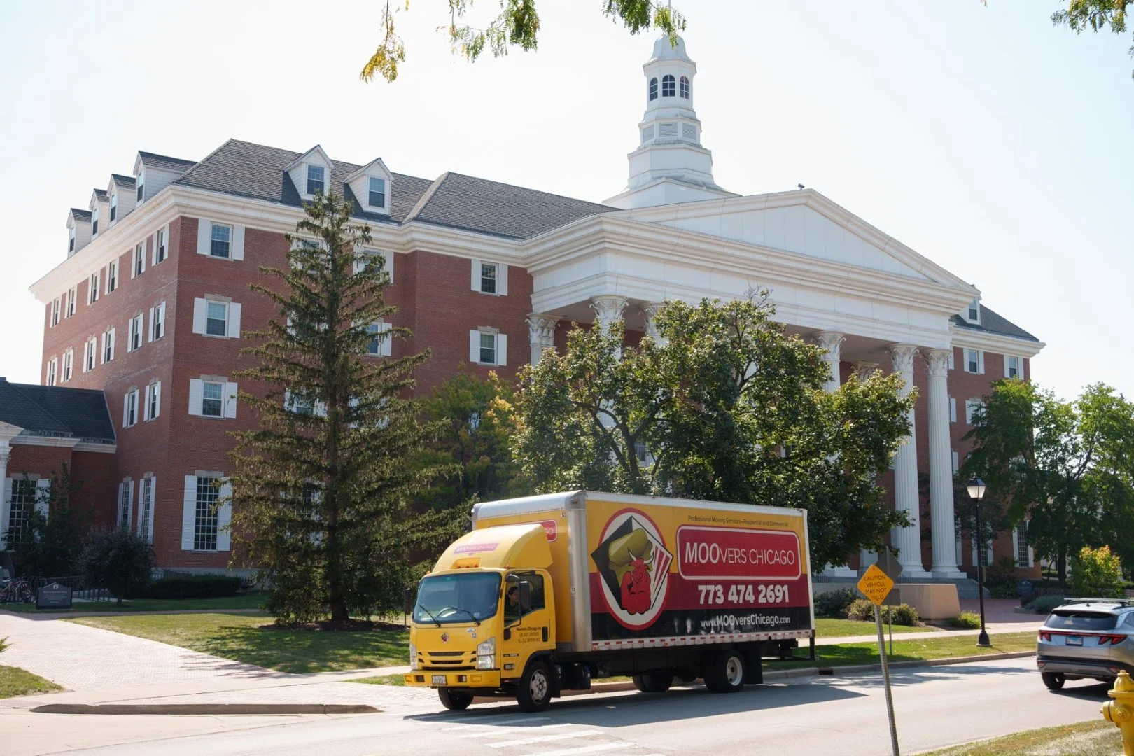 Moovers Chicago Truck at Historic Building Moovers Chicago truck in front of a large building, local and long distance moving services in Wheaton, IL.