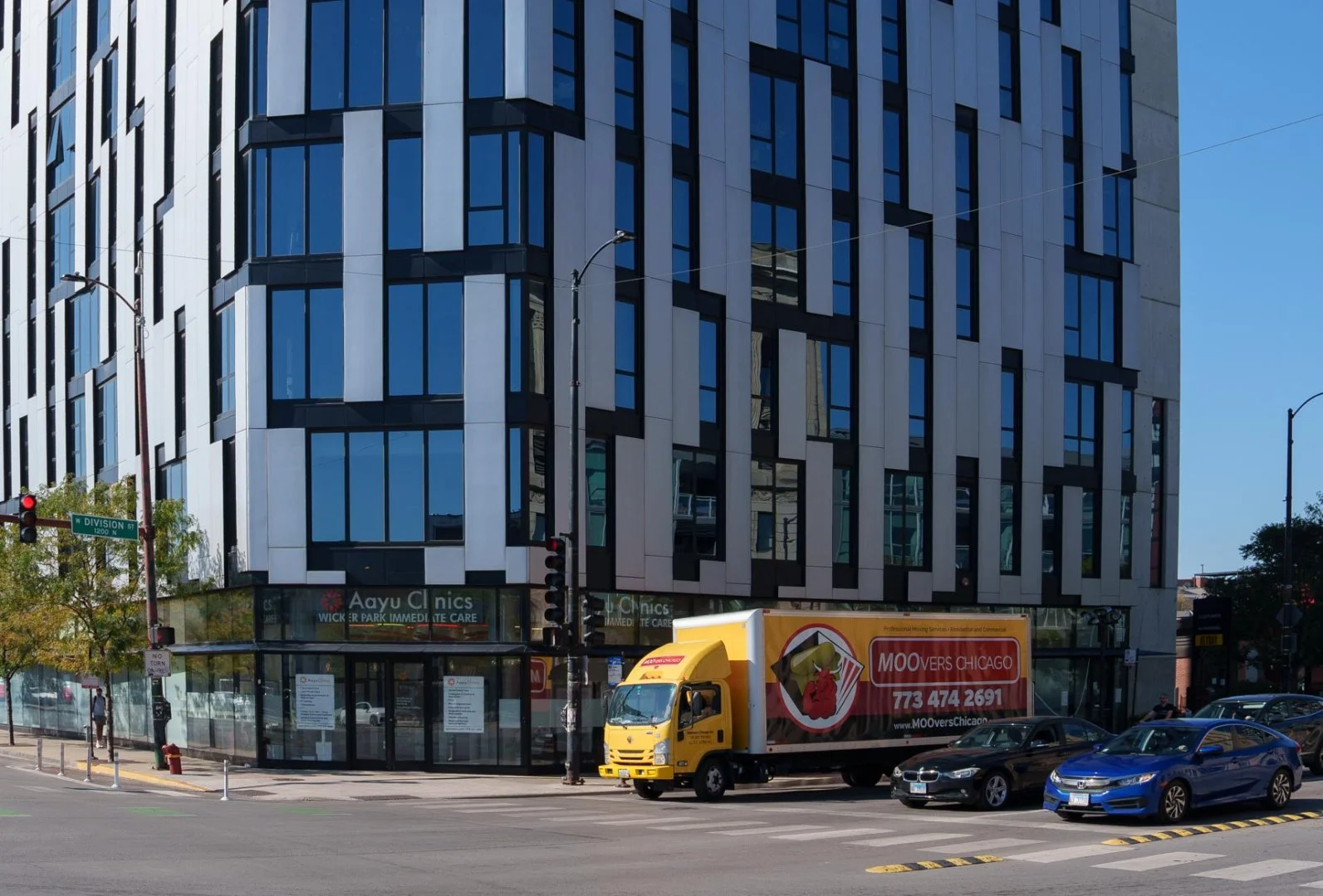 Moovers Chicago Truck in City Moovers Chicago moving truck in front of a modern building, local and long distance moving services in West Town, Chicago, IL.