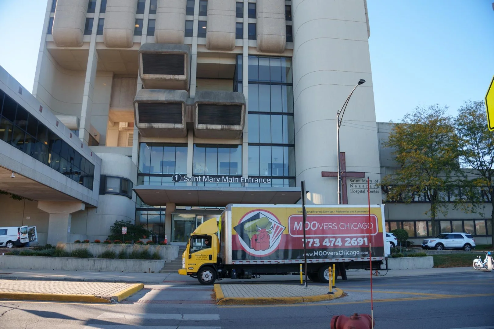 Moovers Chicago truck parked in front of a building, offering local and long distance moving services.
