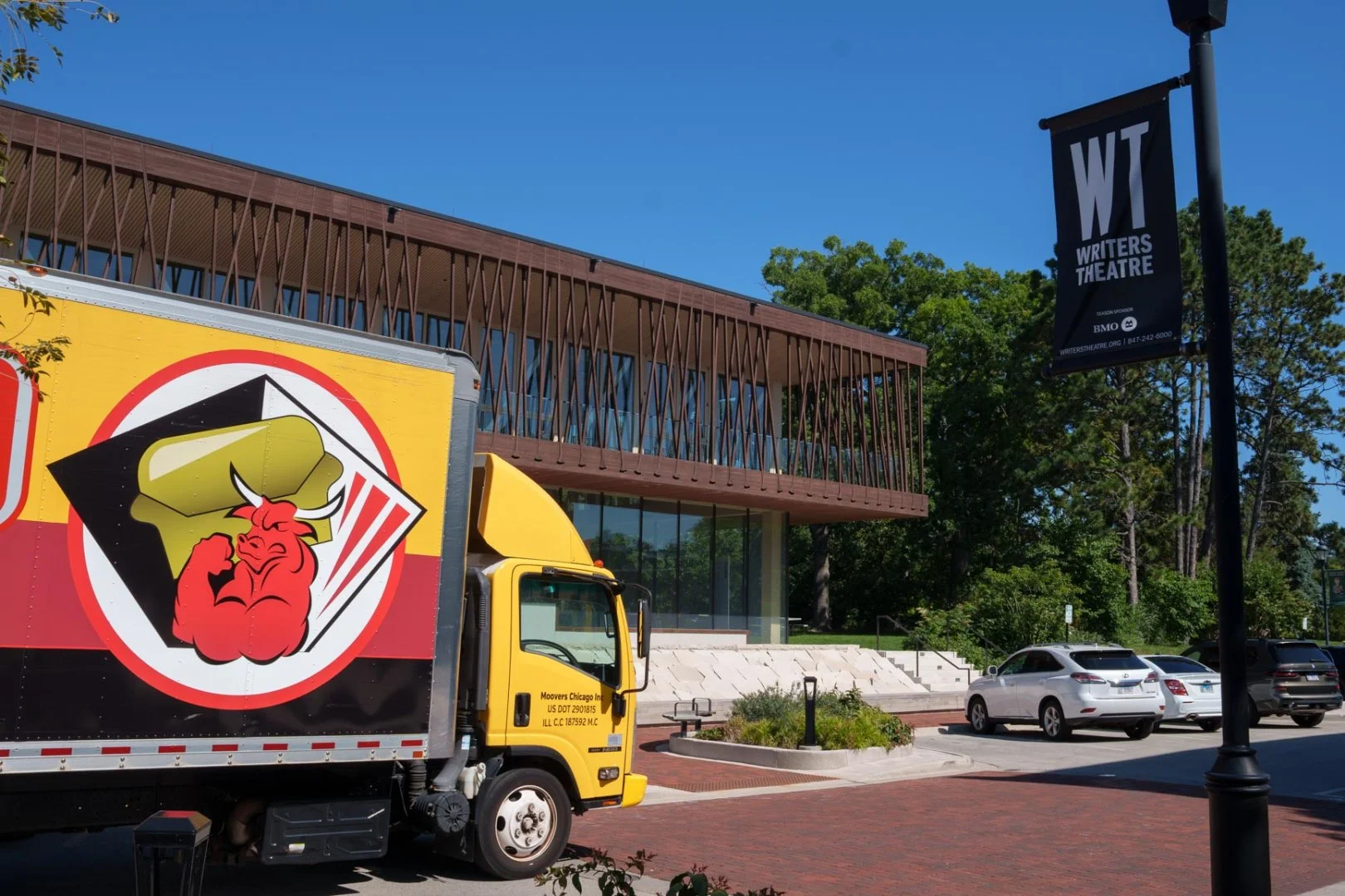 Moovers Chicago Truck at Theater Moovers Chicago truck parked near a theater in Glencoe, IL, offering local and long distance moving services.