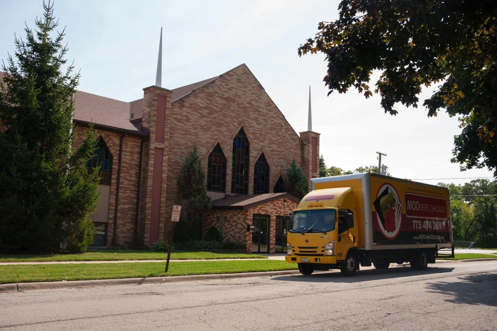 Moovers Chicago Truck Moovers Chicago truck parked near a church, offering local and long distance moving services in North Chicago, IL.