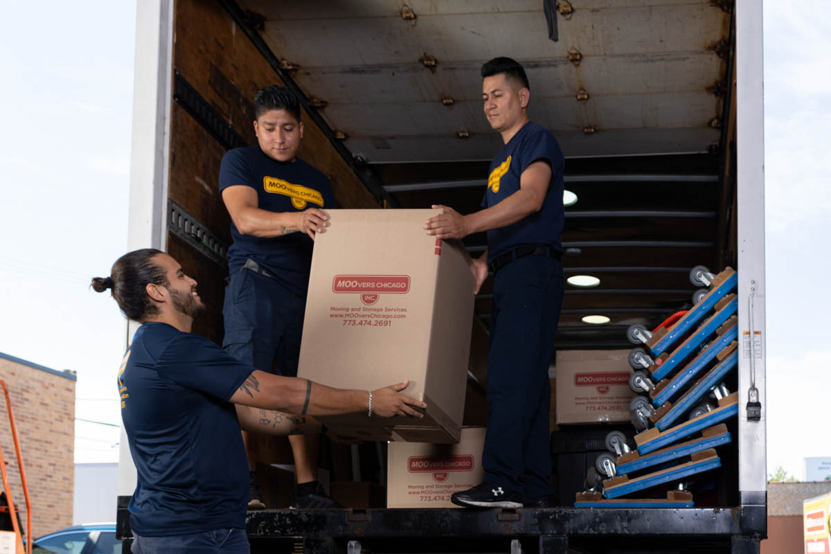 Moovers Chicago team loading boxes into a truck, local and long distance moving services.