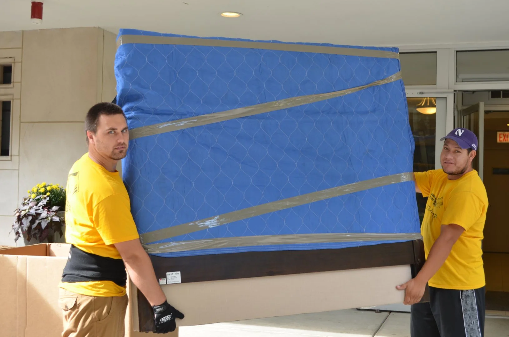 Moovers Chicago - Professional Movers Movers carrying furniture for Moovers Chicago, a local moving company.