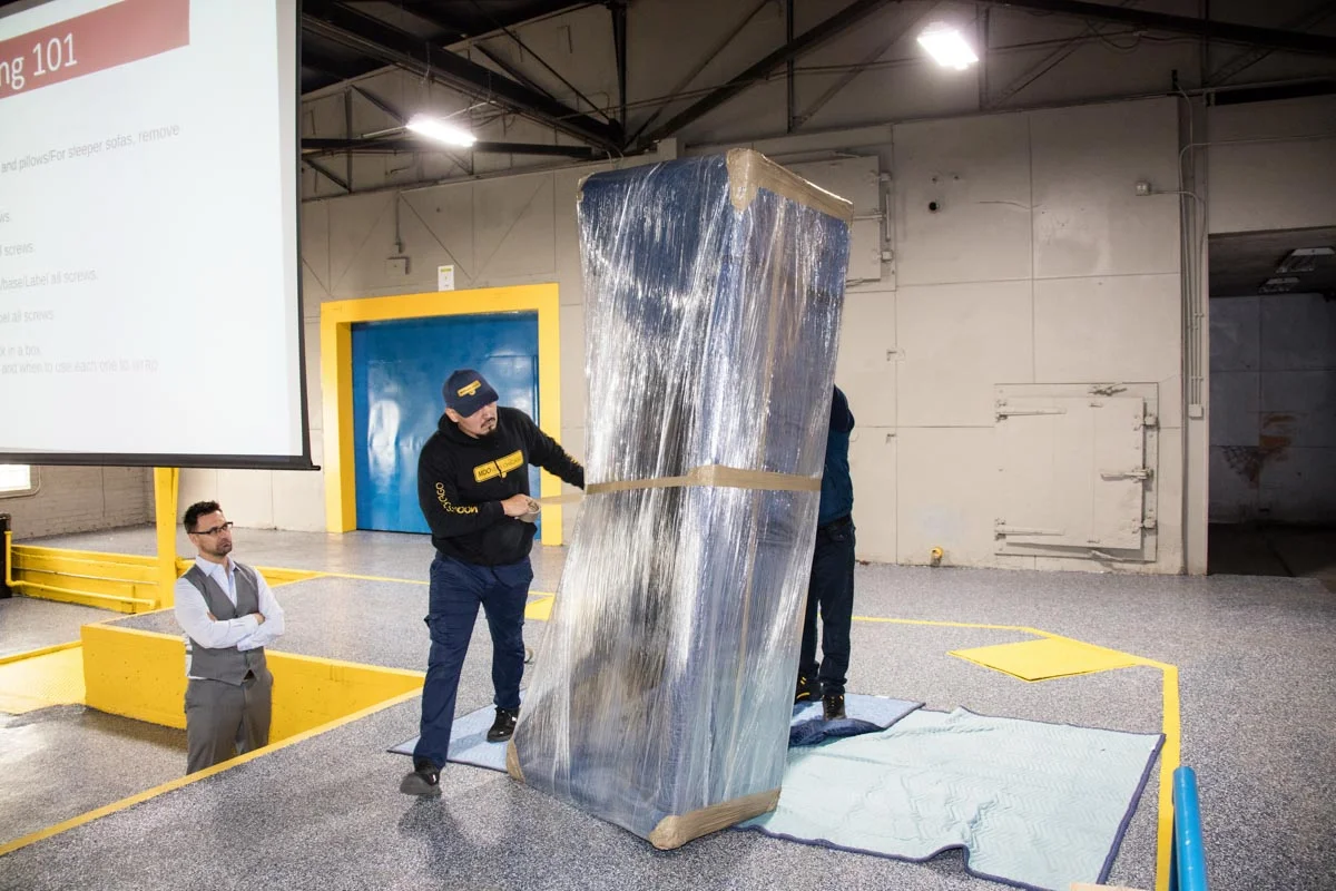 Professional movers wrapping furniture for Moovers Chicago.