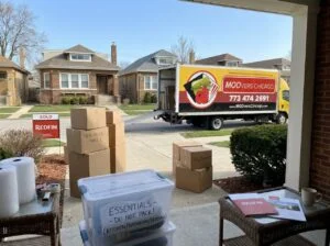 Moovers Chicago truck and moving boxes in residential area.