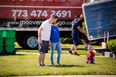 A couple standing outside a Moovers Chicago truck, ready for a residential long-distance move with a trusted Chicago long-distance moving company.