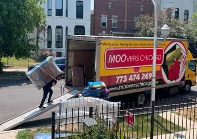 Moovers Chicago truck with movers loading furniture, local and long distance moving services.