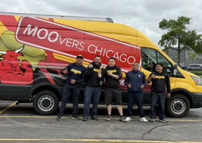 Moovers Chicago team in front of branded moving van, offering local and long distance moving services.