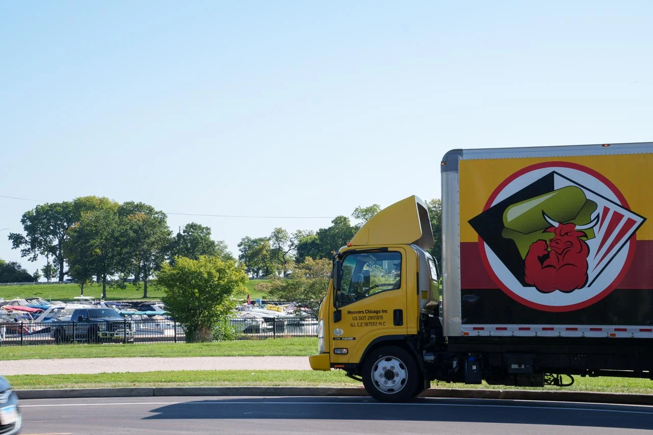 Moovers Chicago moving truck parked in a scenic area, offering local and long distance moving services.