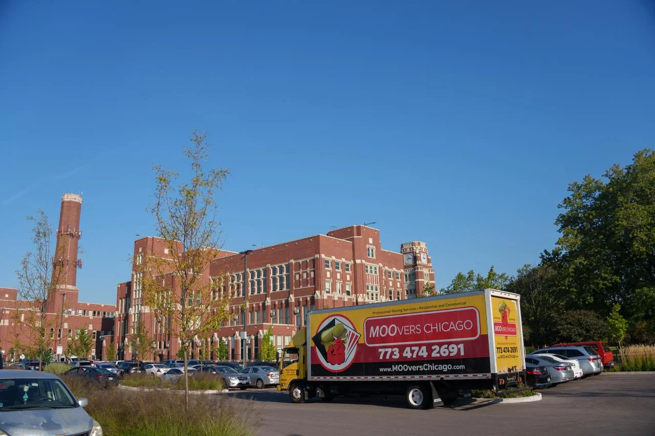 Moovers Chicago truck parked in front of a building, offering local and long distance moving services.