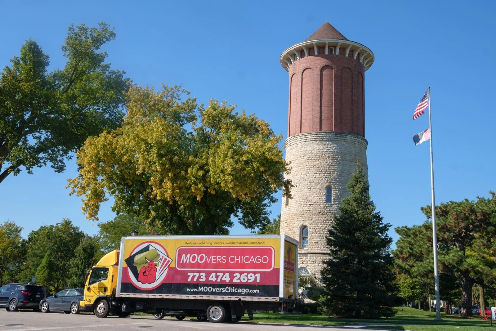 Moovers Chicago moving truck parked near a historic tower in Western Springs, IL.