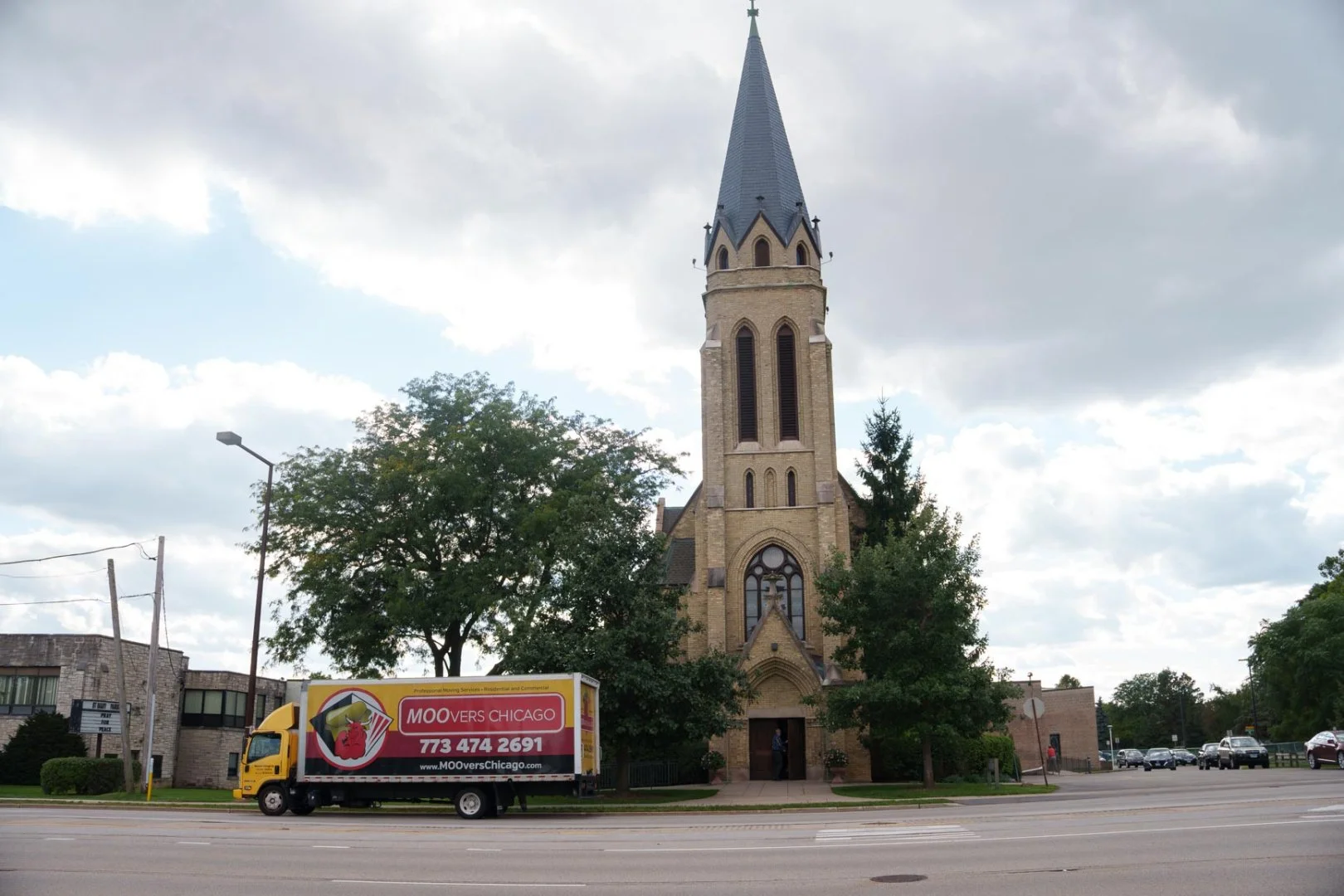 Moovers Chicago truck parked in front of a church, offering local and long distance moving services in Buffalo Grove, Illinois.