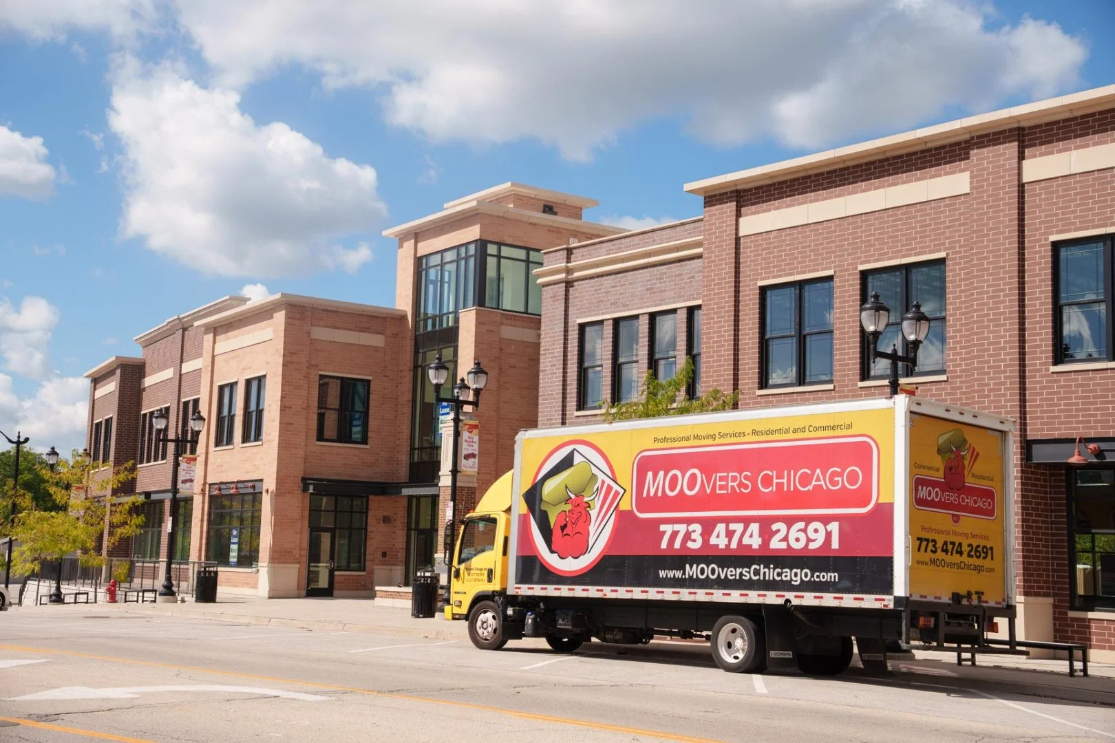 Moovers Chicago truck parked in front of a building, offering local and long distance moving services in Mundelein, IL.