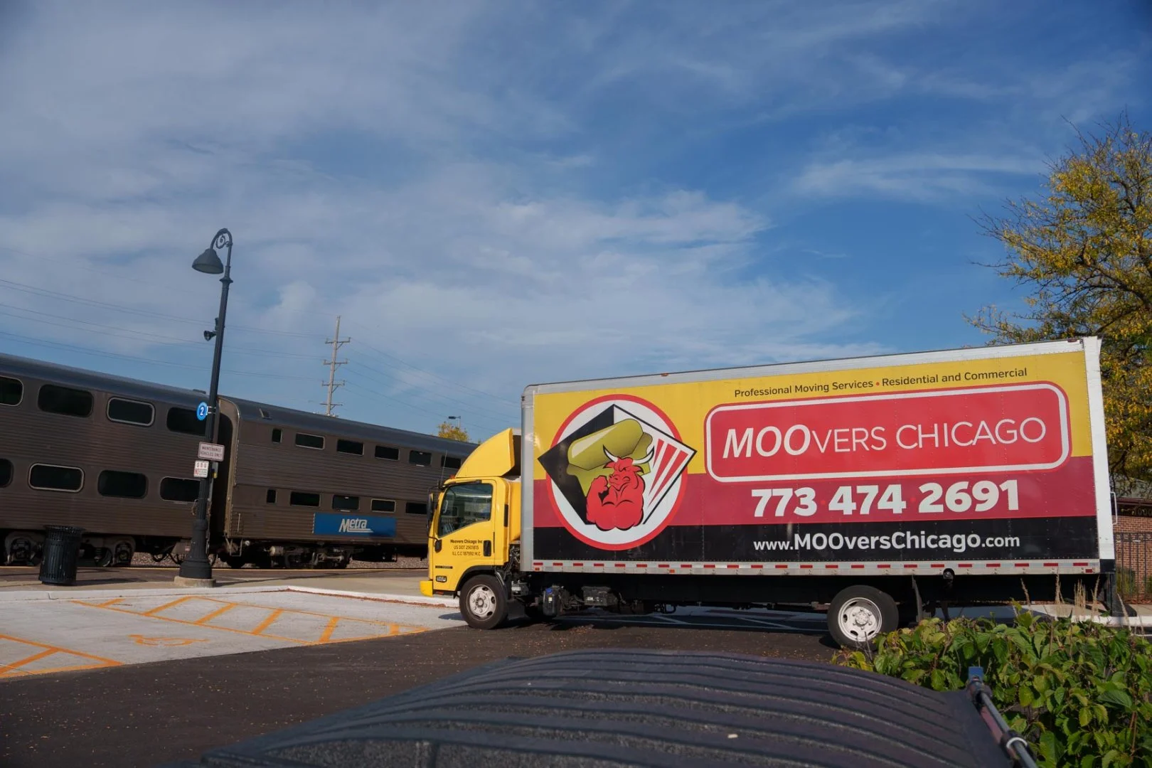 Moovers Chicago truck parked near a train, offering moving services in Hinsdale, IL.