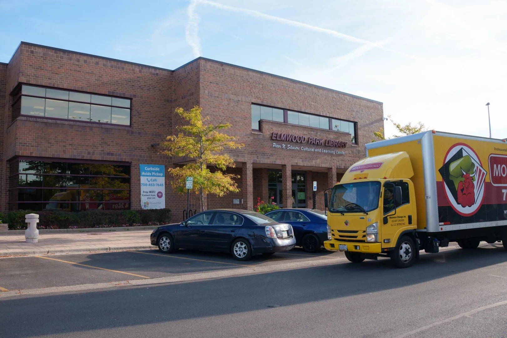 Moovers Chicago truck parked outside Elmwood Park Library, IL local and long distance moving services.