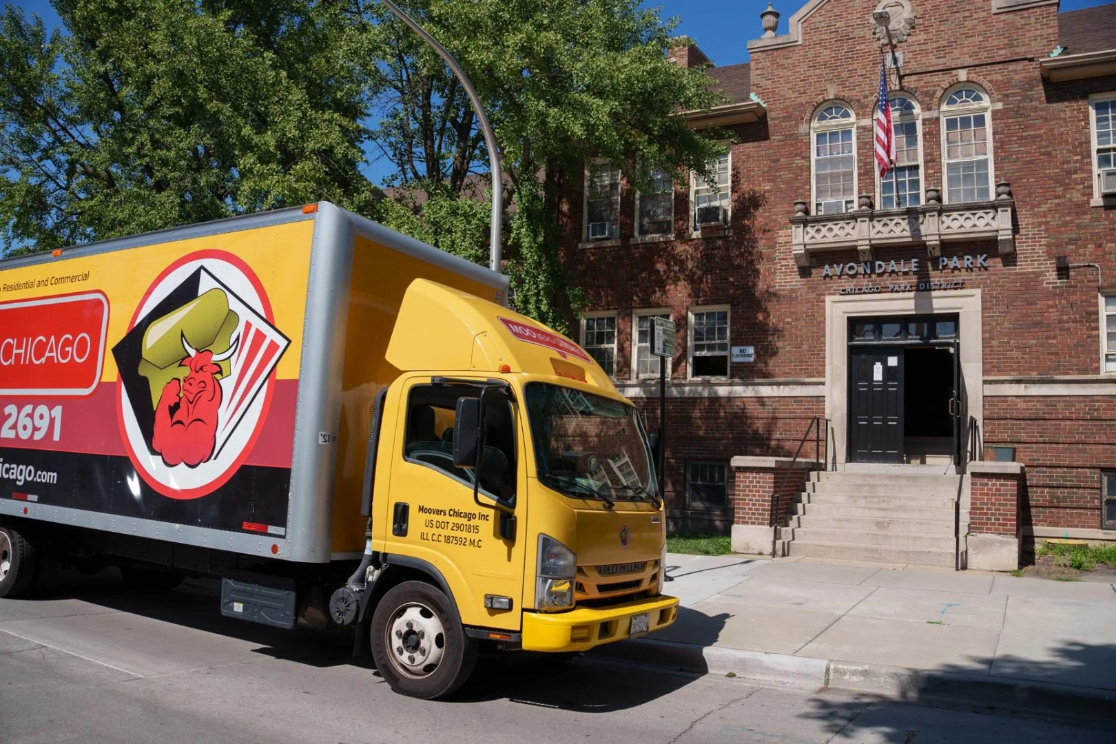 Moovers Chicago truck parked outside a building, offering local and long distance moving services in Avondale.
