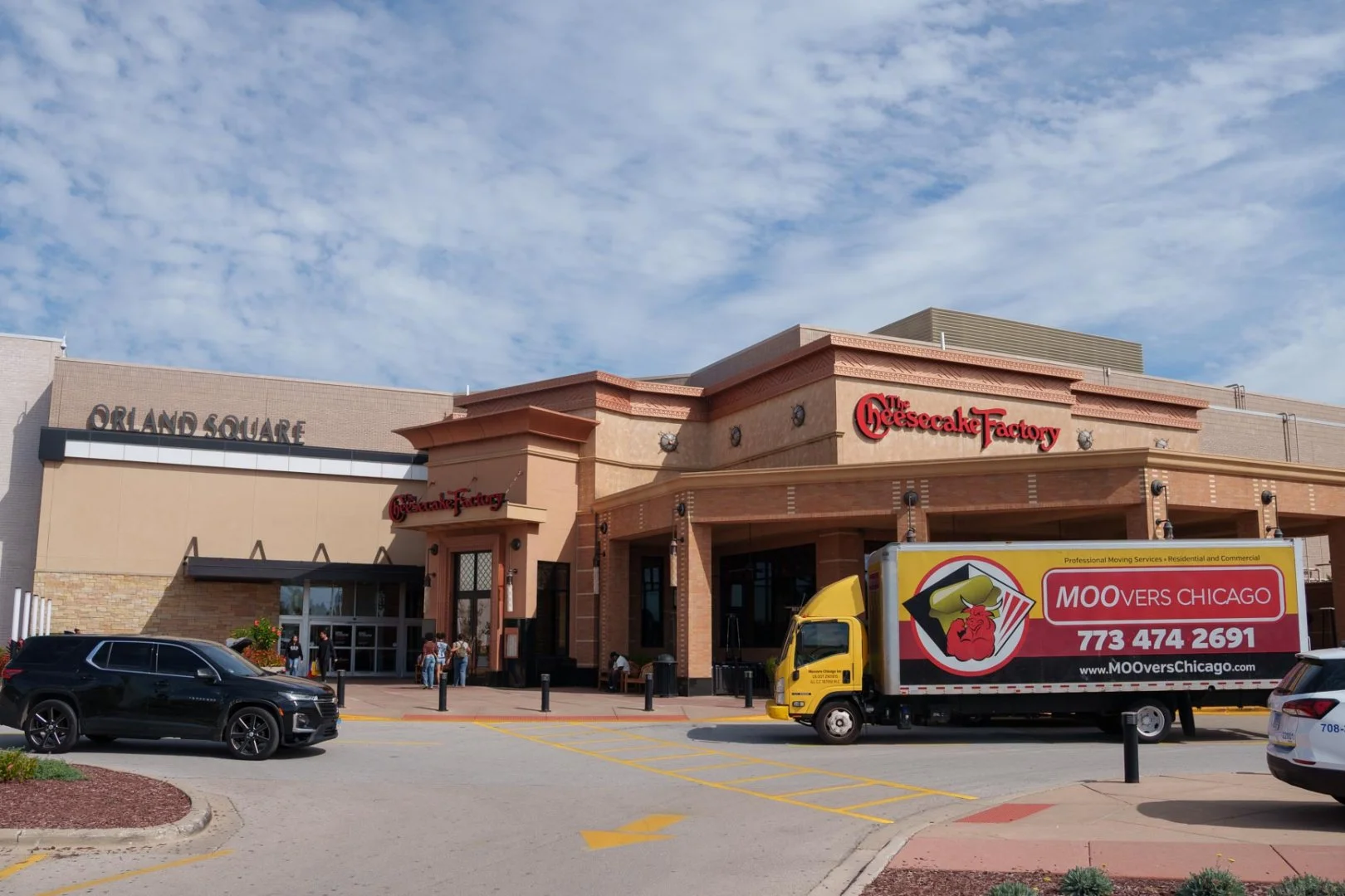 Moovers Chicago truck parked outside a shopping center, offering local and long-distance moving services.