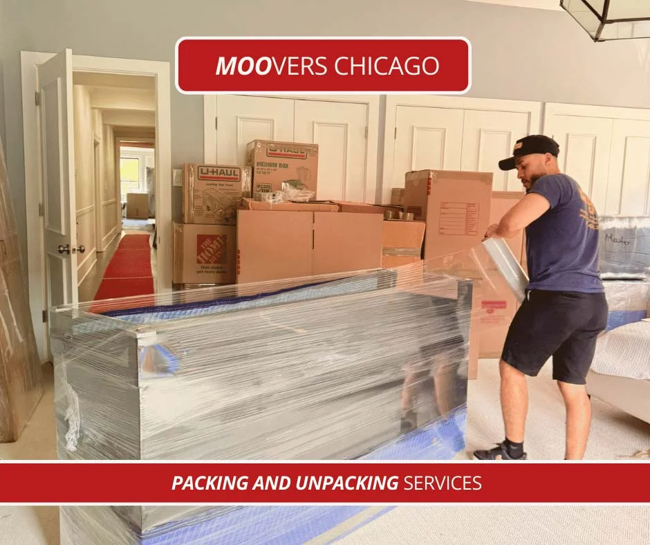 Mover packing furniture in a room with boxes, Moovers Chicago.