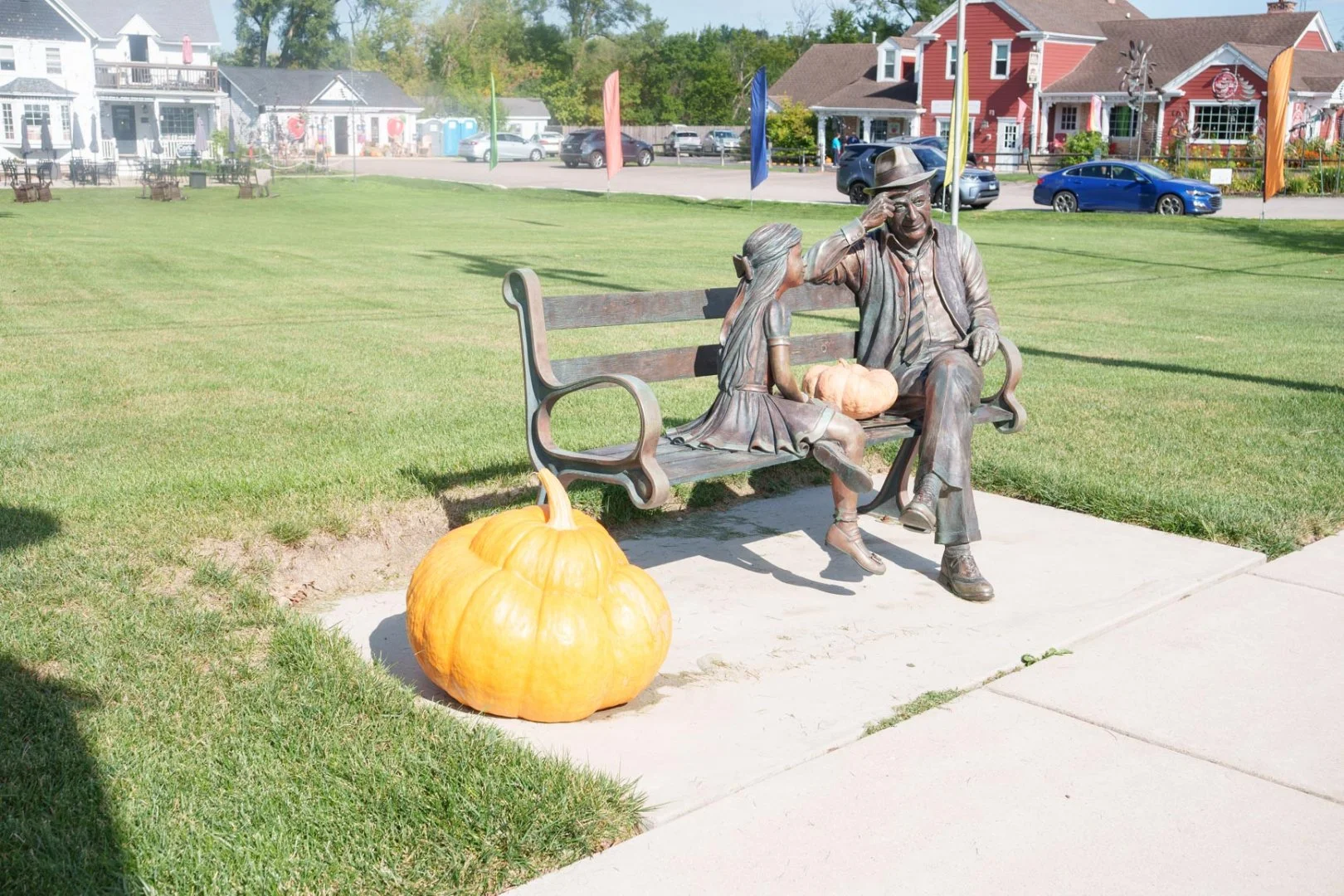 Statue of a man and girl on a bench with pumpkins, near local moving services in Long Grove, IL.