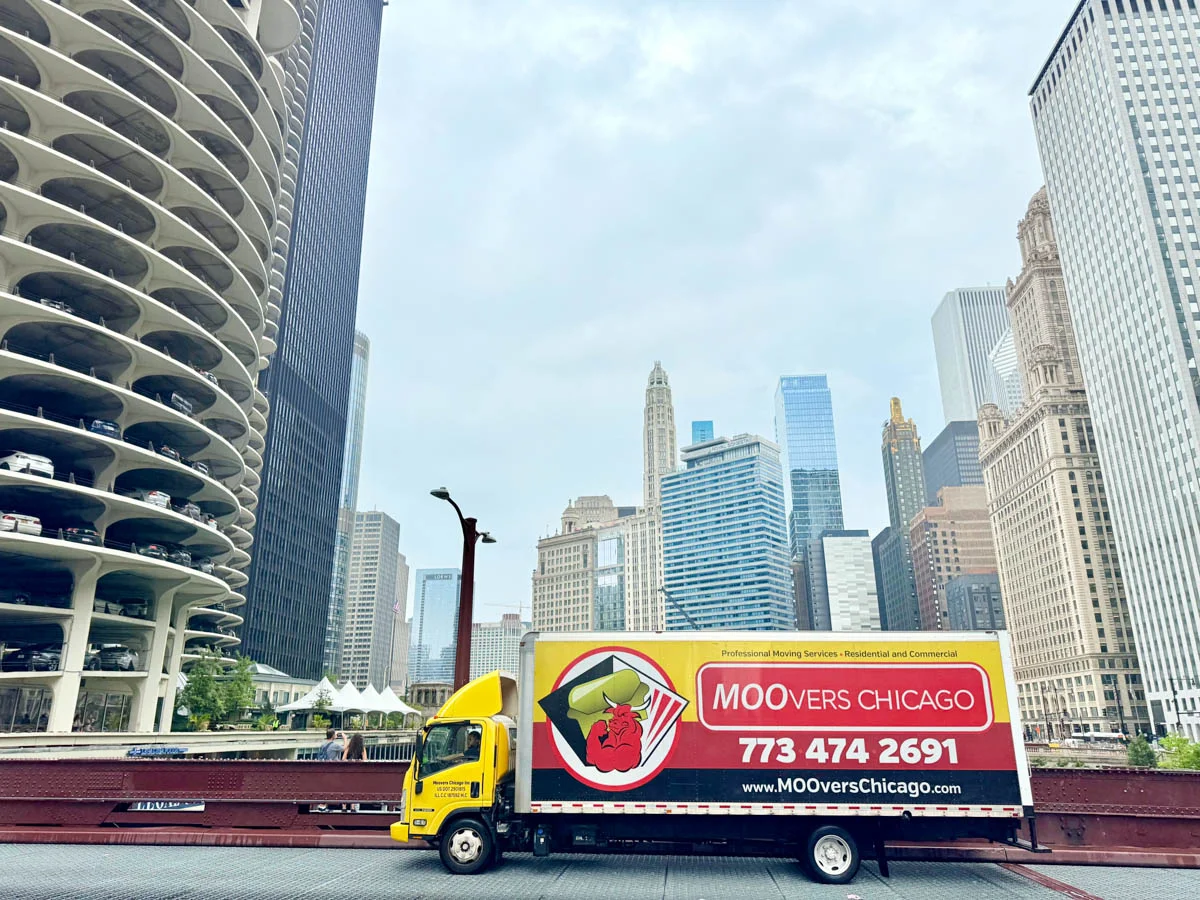 Moovers Chicago truck in cityscape, offering moving services.