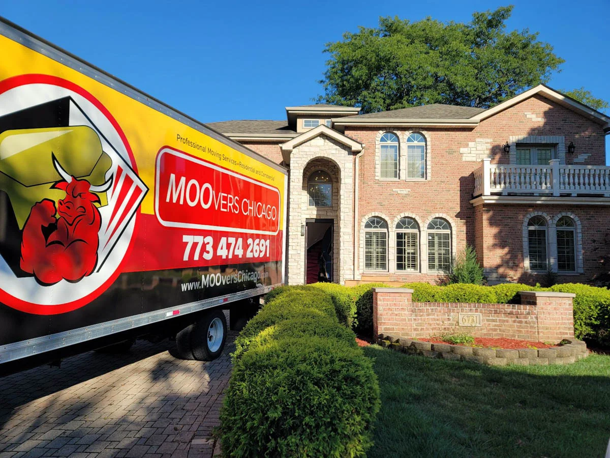Moovers Chicago truck parked in front of a brick house, local and long distance moving services.