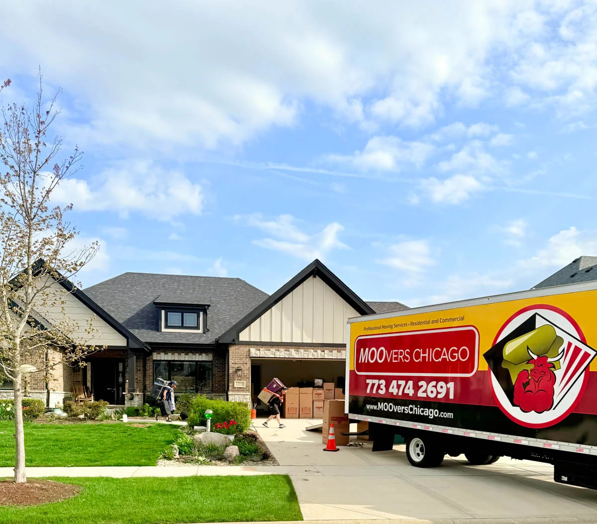 Moovers Chicago truck parked outside a house, moving services in progress.